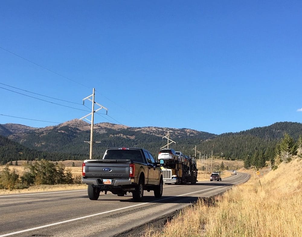 A photo of Targhee Pass on US-20. A highway with vehicles on it.