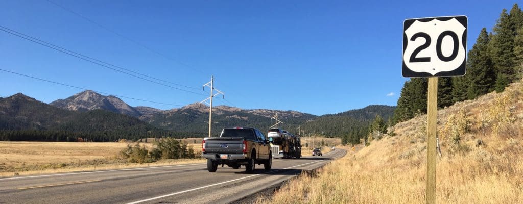 A photo of Targhee Pass on US-20. A highway with vehicles on it.